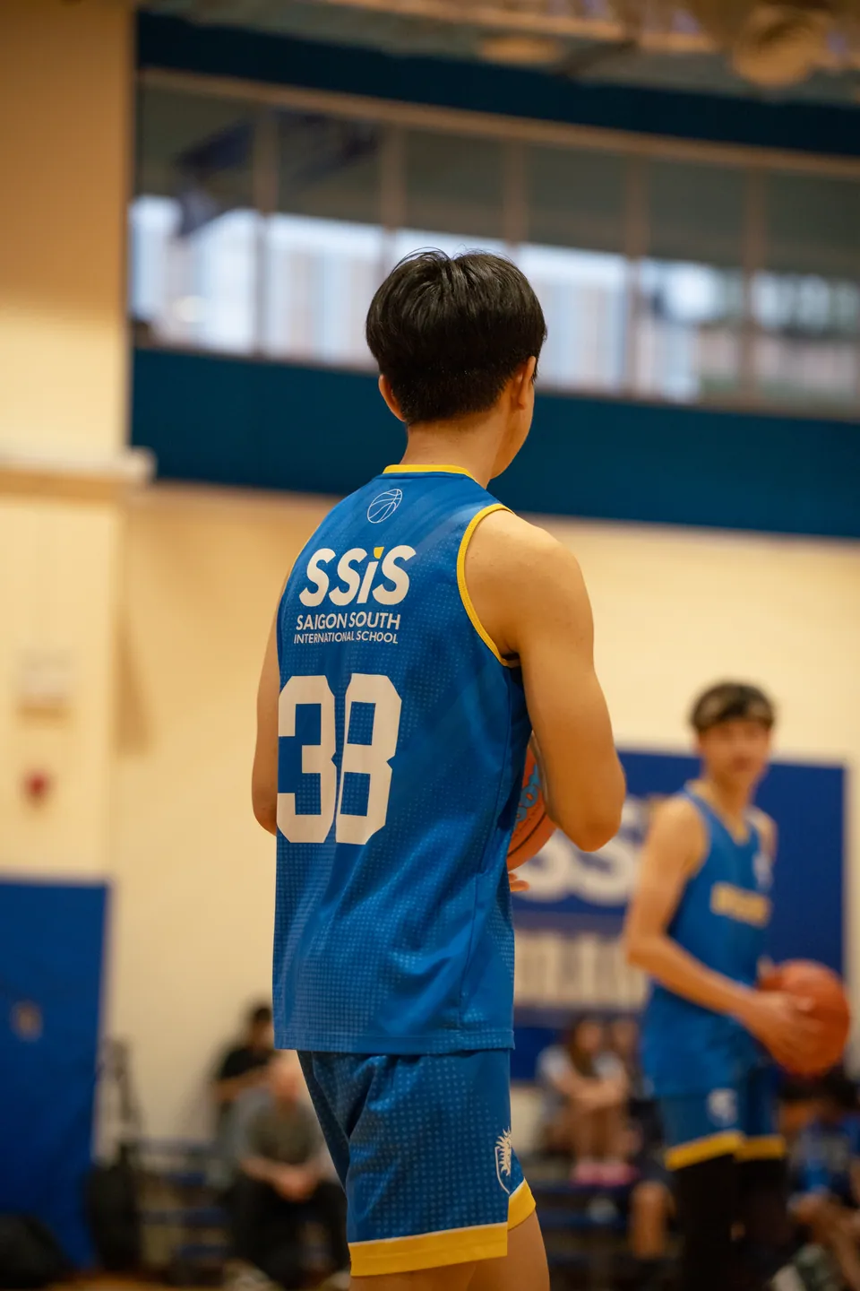 Player in a blue number 33 jersey seen from behind