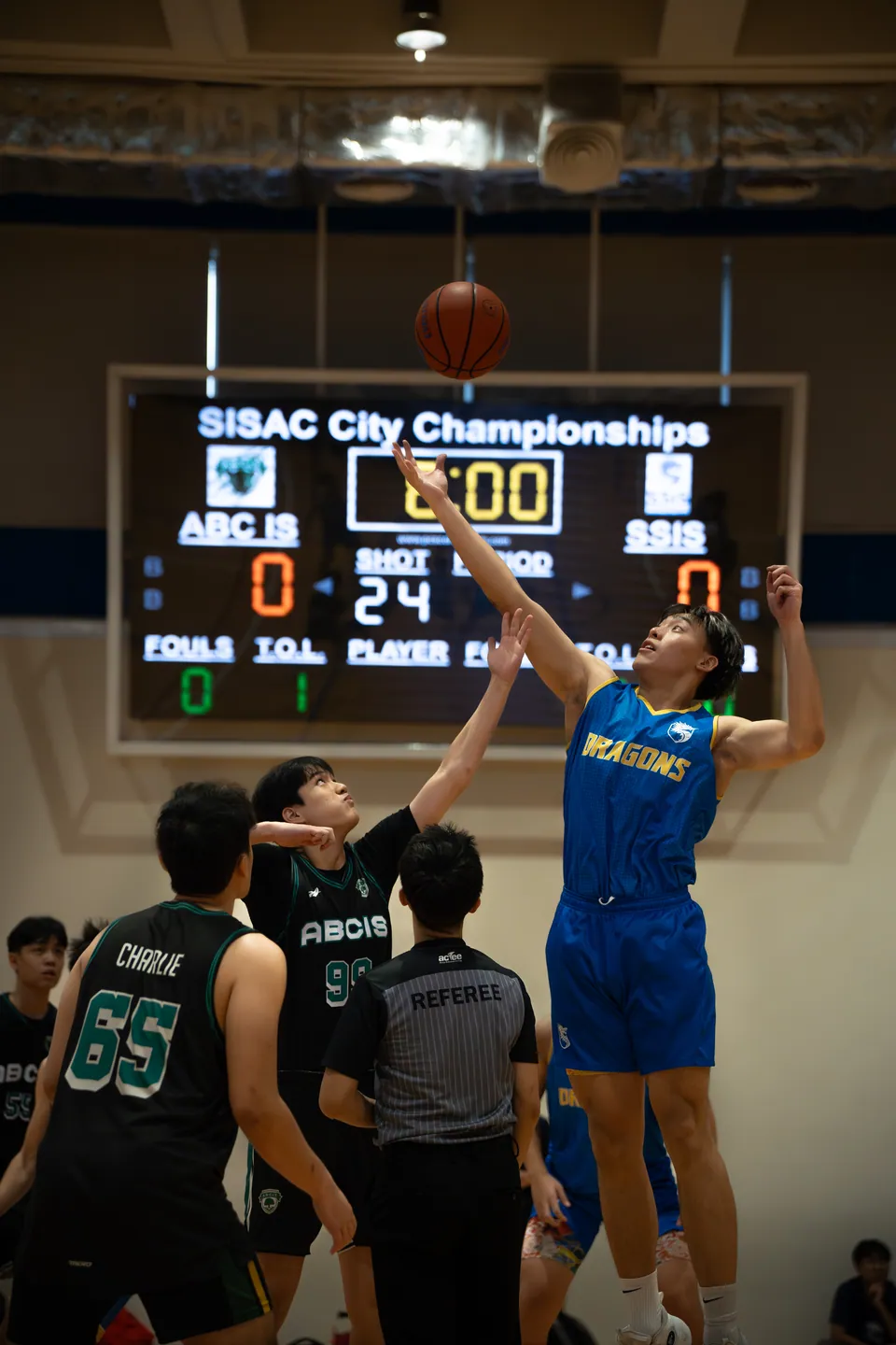 Player shooting beneath a scoreboard reading zero