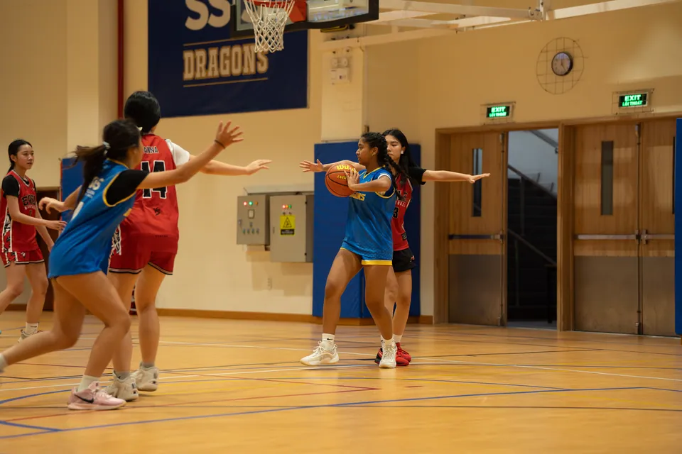 Girls' basketball game in progress indoors