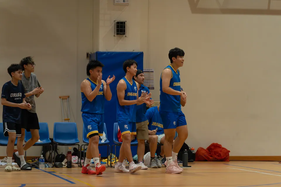 Substitutes standing and applauding courtside
