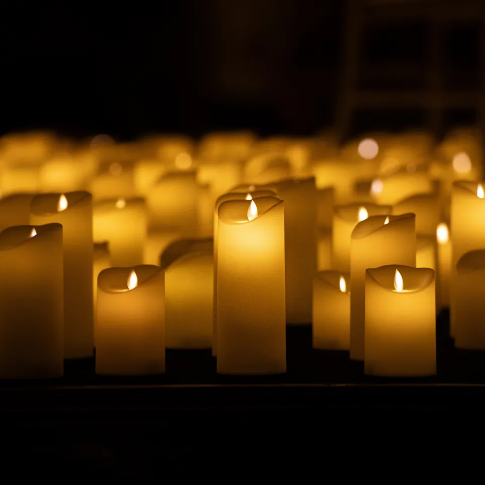 Rows of lit pillar candles