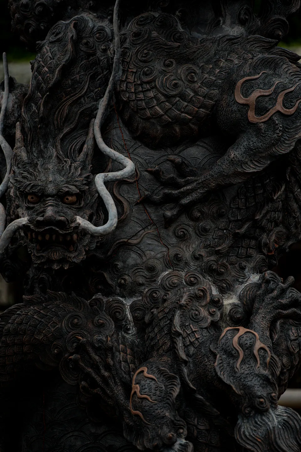 Weathered carved dragon relief, cracked with age