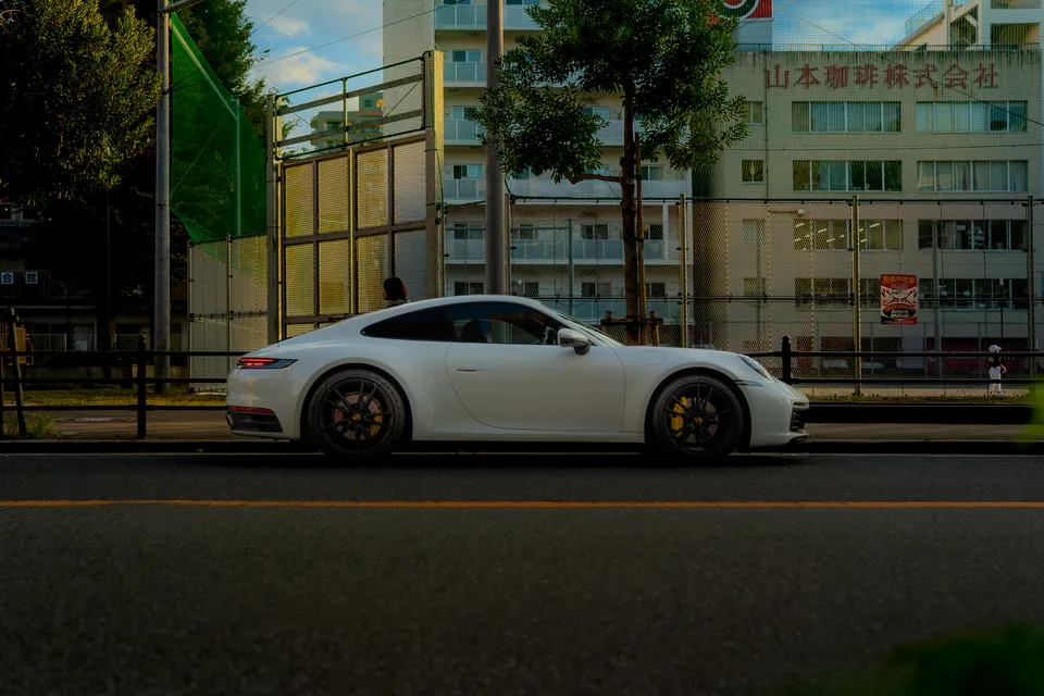 White sports car seen side-on against a city street